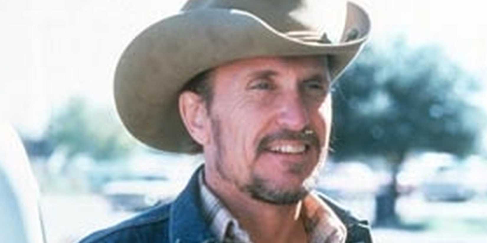 Mac smiles at something off-camera in Tender Mercies.