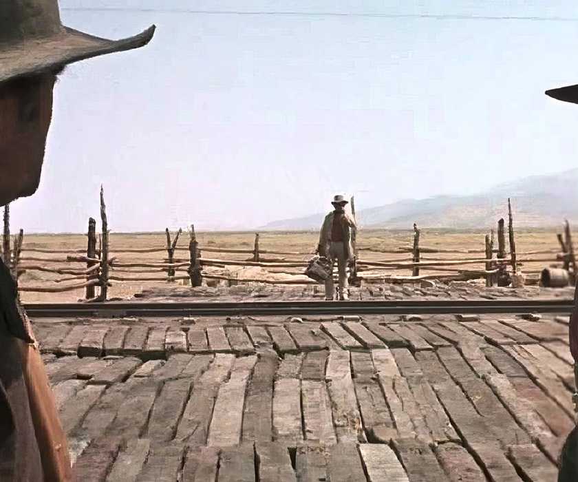 Snaky (Jack Elam) and Stony (Woody Strode) look at Harmonica (Charles Bronson) standing by in 'Once Upon a Time in the West'