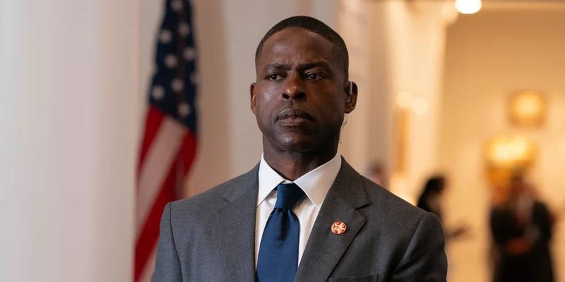 Sterling K. Brown as Agent Xavier Collins in Paradise stands in front of a US flag