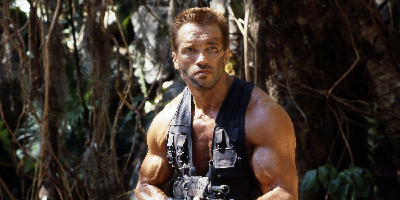 Arnold Schwarzenegger in the jungle looking to the distance in 'Predator' (1987).