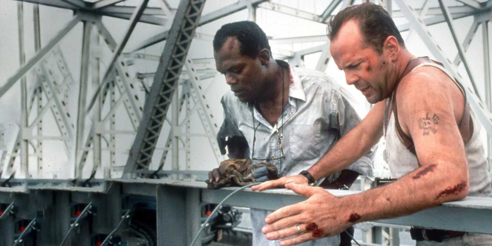Samuel L. Jackson as Zeus Carver and Bruce Willis as John McClane stand on a bridge in 'Die Hard With a Vengeance'