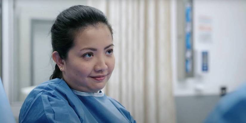 Nurse Princess (Kristin Villanueva) smiles during a surgery in the medical drama The Pitt.
