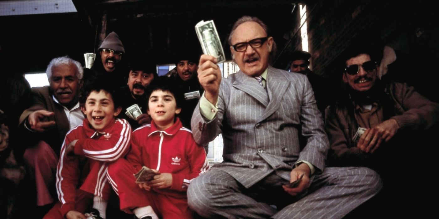 Gene Hackman as Royal wearing a grey suit holding cash in 'The Royal Tenenbaums'