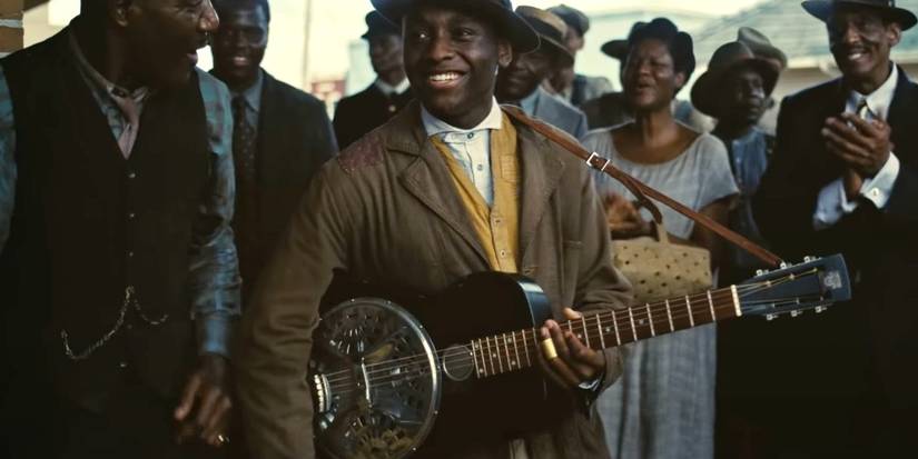 Sammie (Miles Caton) plays his guitar for a crowd in Sinners.