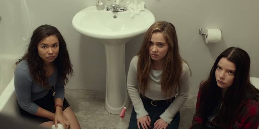 Jessica Sula, Haley Lu Richardson, and Anya Taylor-Joy sit on a bathroom floor looking up in Split