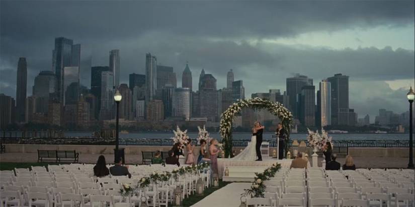 A wedding with very few attendees against a city backdrop with a cloudy sky in Succession Season 4.