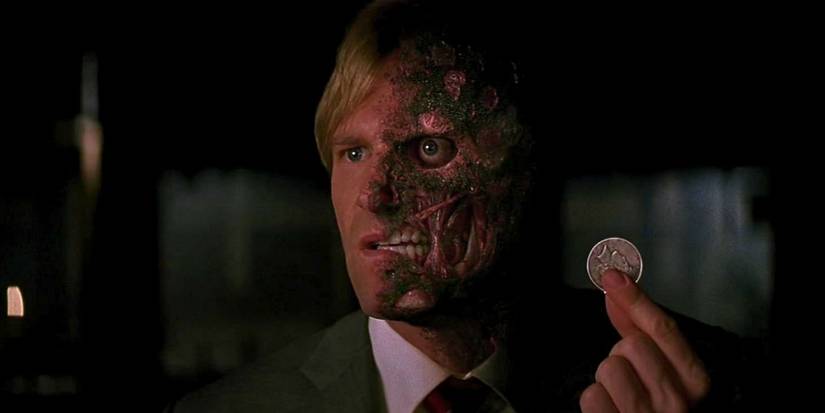 Harvey Dent presenting his coin to Gordon in The Dark Knight 
