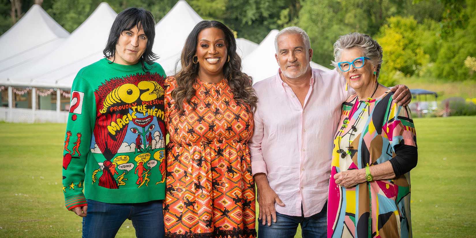 The hosts and judges of The Great British Bake Off smile and stand outside the white tent.