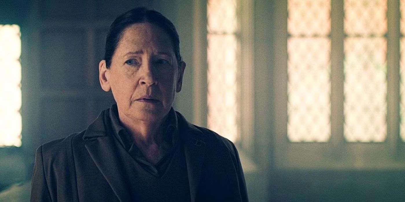 Ann Dowd as Aunt Lydia, looking off camera with concern, in a still from The Handmaid's Tale.