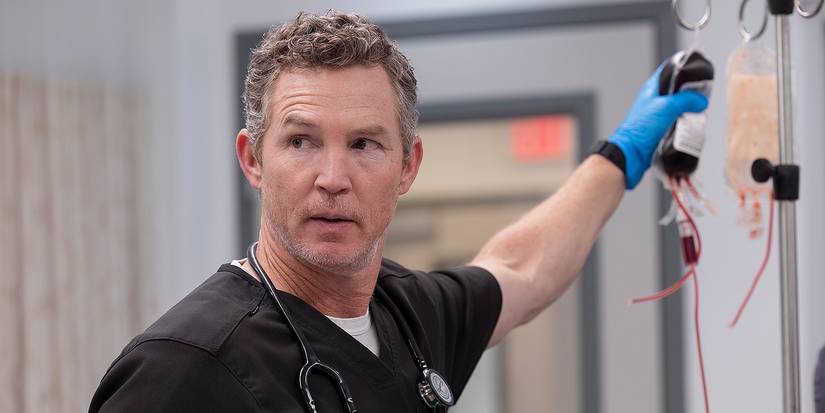 Shawn Hatosy as Dr. Abbot holding a blood bag and looking to the side in The Pitt Season 1, Episode 15.