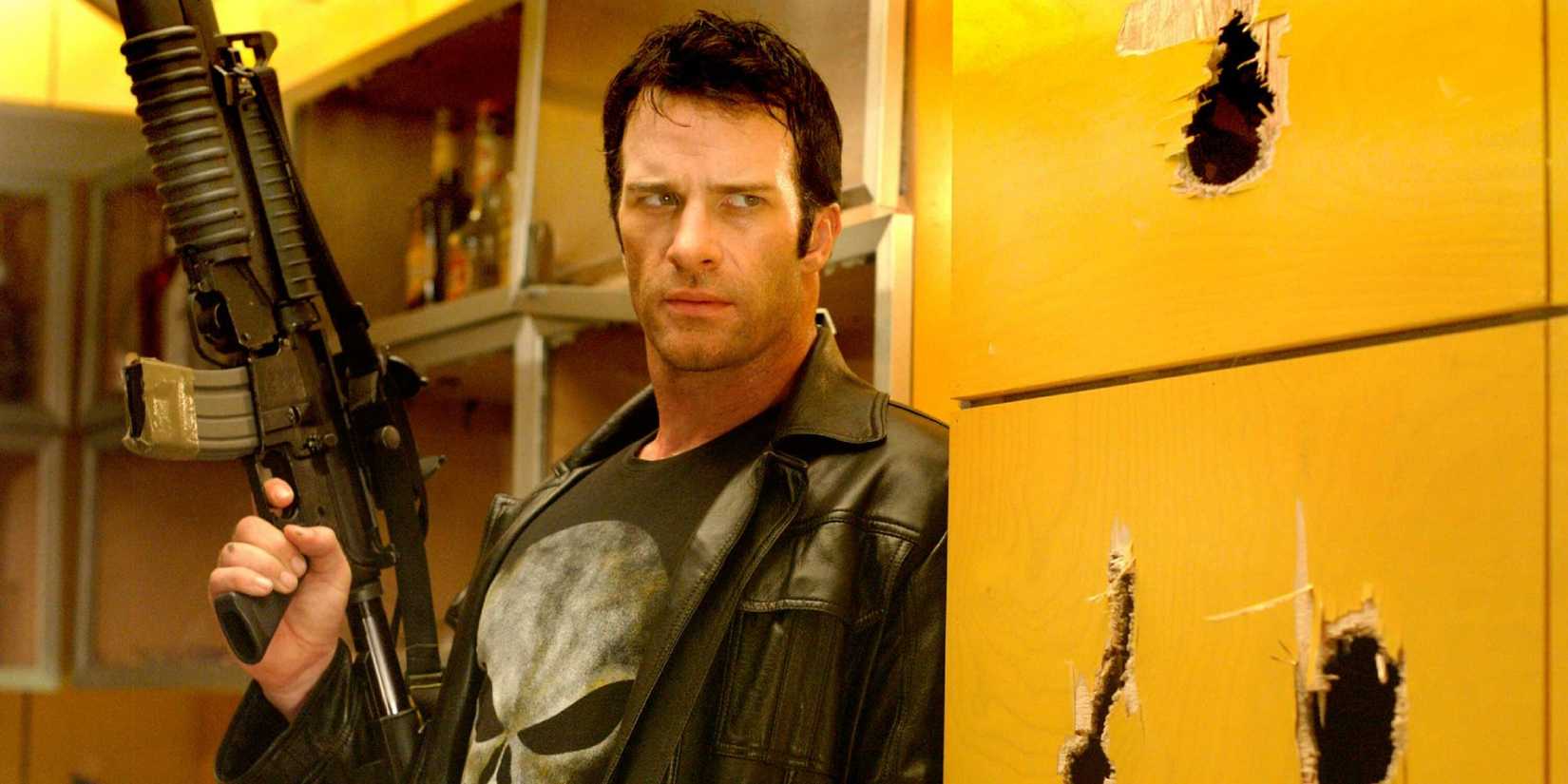 The Punisher holding a gun and looking intently