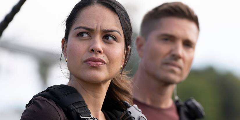 Alyssa Diaz looking to the side, concerned, with Eric Winter behind her from The Rookie.