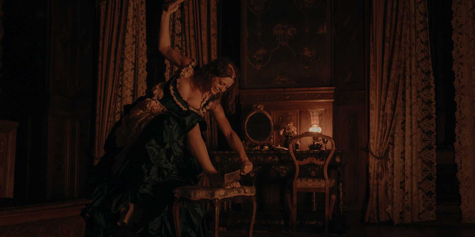 Lea Myren as Elvira holds an axe preparing to cut off her toes in The Ugly Stepsister 