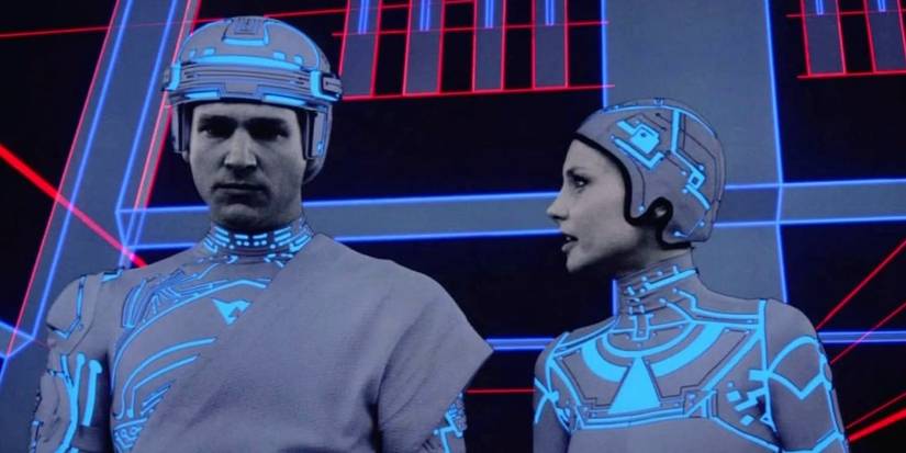 Jeff Bridges as Kevin Flynn and Cindy Morgan as Yori side by side with digital art all around them in 'Tron'