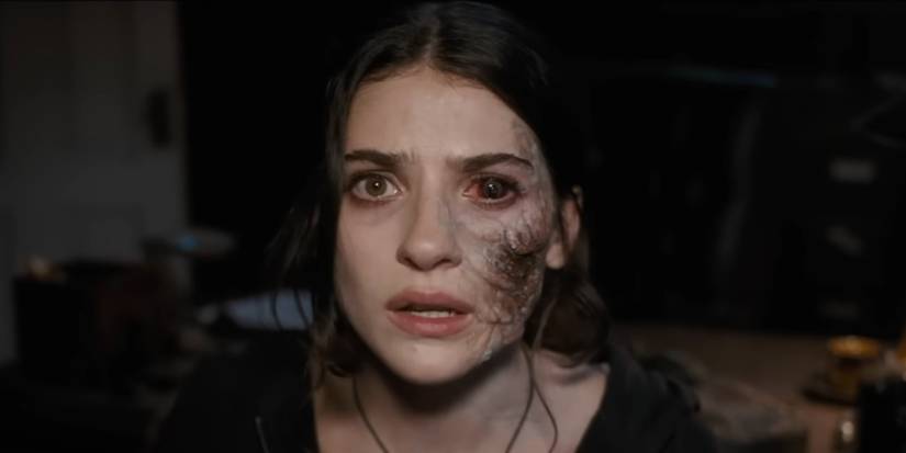 Ella Rubin sebagai Clover dengan urat hitam menutupi satu sisi wajah dan satu matanya di Until Dawn.