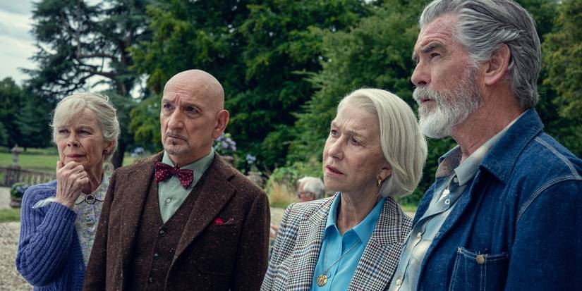 The cast of The Thursday Murder Club standing outside and looking in the same direction.