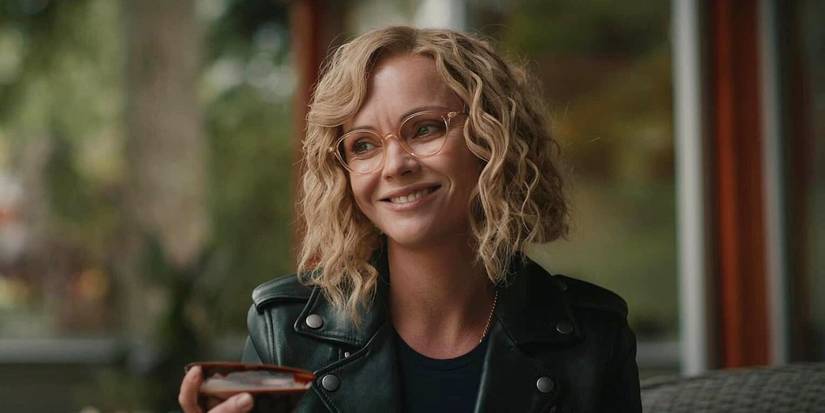 Misty Quigley gives a fake smile with one of Walter's chocolate martinis in Yellowjackets.