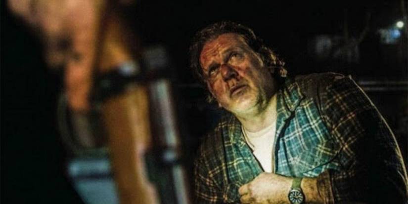 Erik Thomson as Alan, bloodied and bruised and looking up fearfully in Coming Home In The Dark