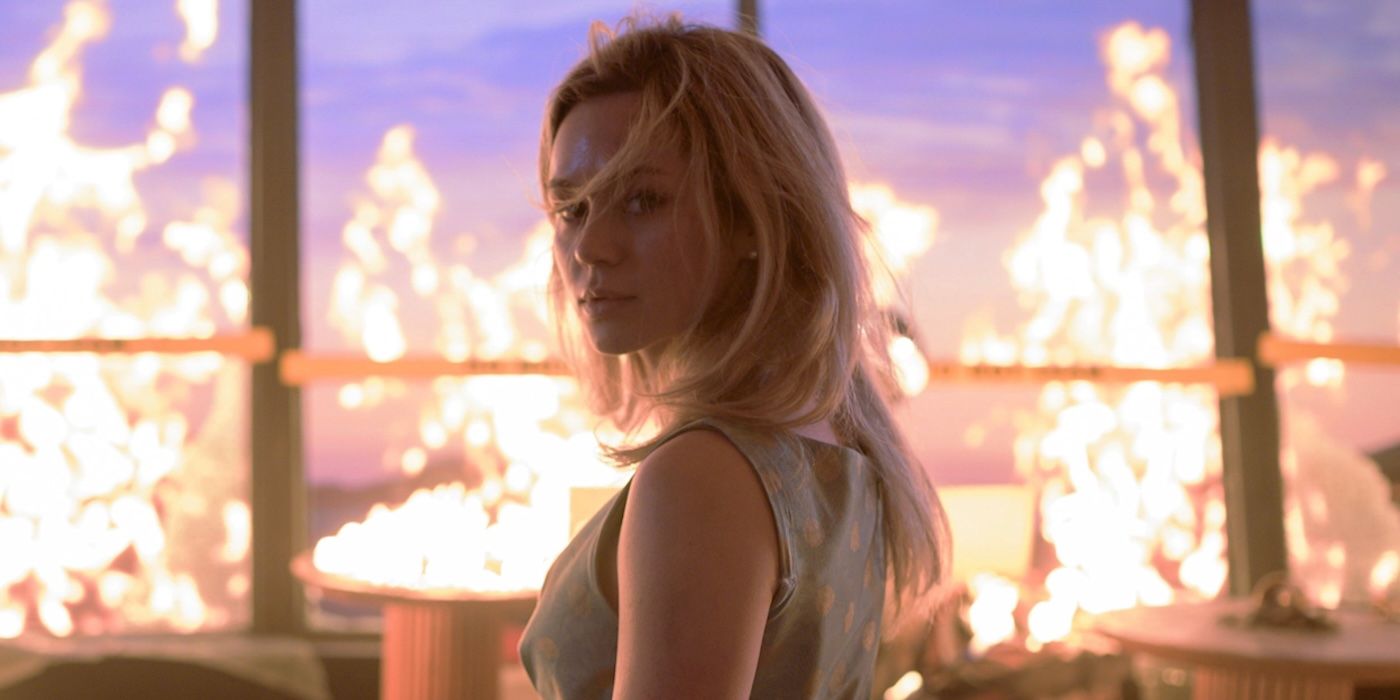 Brec Bassinger as young Iris Campbell, standing in a burning building in Final Destination Bloodlines