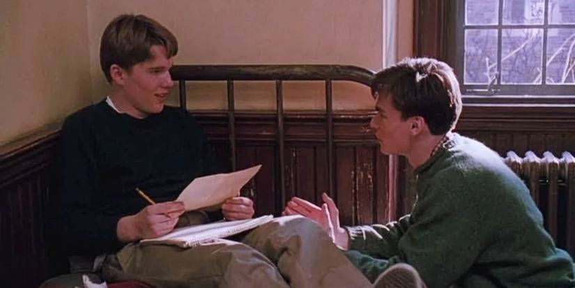 Todd Anderson sitting on his bed while Neil Perry talks to him in Dead Poets Society