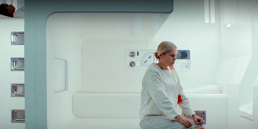 Dedra Meero (Denise Gough) wearing an inmate's uniform and sitting in her Imperial prison cell in Andor Season 2