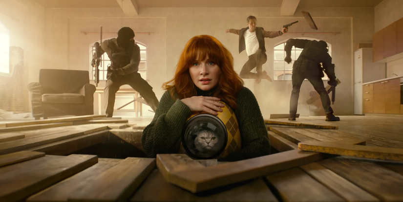 bryce dallas howard emerges from the floor with her cat while sam rockwell fights bad guys