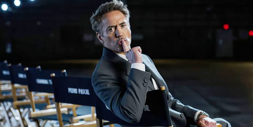 Robert Downey Jr looking at the camera and making a shushing motion.