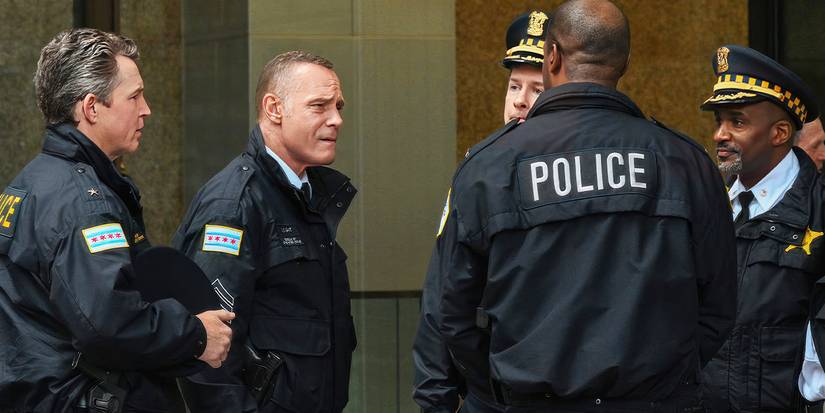 Jason Beghe as Hank Voight in police outfits standing in a lobby in the Season 12 finale of Chicago P.D.