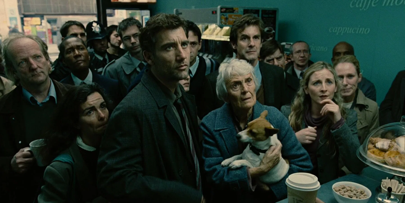 Clive Owen and other civilians watch television off camera in Children of Men (2006)
