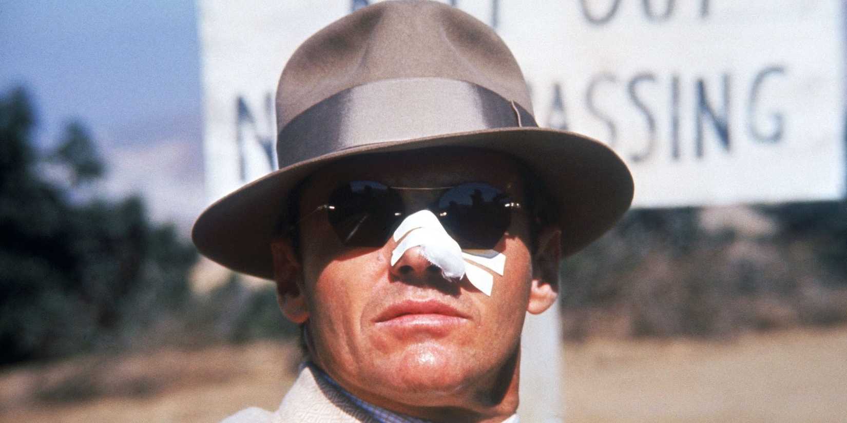 Jack Nicholson as Jake Gittes with a broken nose looking ahead in Chinatown. 