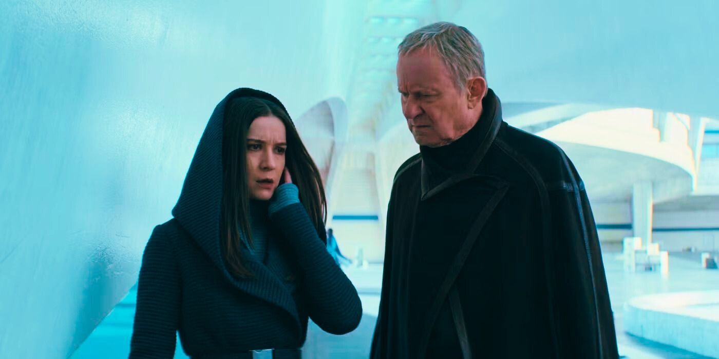 Elizabeth Dulau and Stellan Skarsgård having a conversation in a white building in Andor Season 2. 