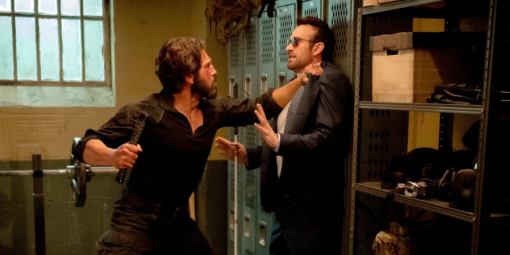 Charlie Cox is pinned to a locker with one hand by Jon Bernthal in 'Daredevil: Born Again.'
