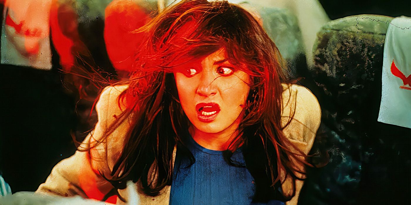 Actor Kristen Cloke as Miss Lewton, in a plane seat looking scared as a red light glows on her face in Final Destination.