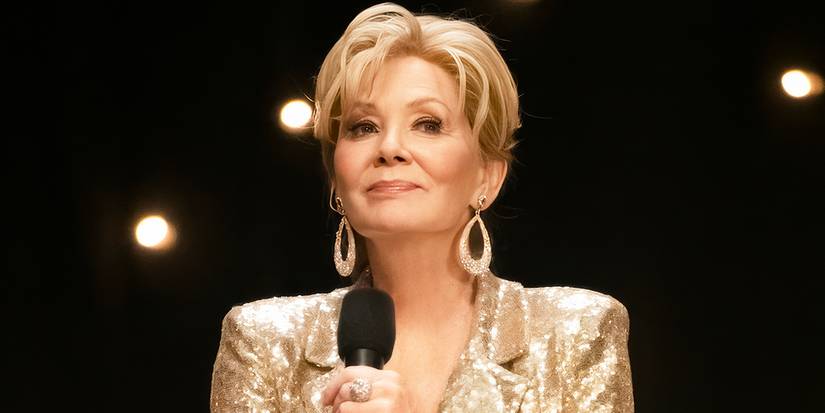 Jean Smart's Deborah in a gold outfit holding a microphone in the Season 1 finale of Hacks.