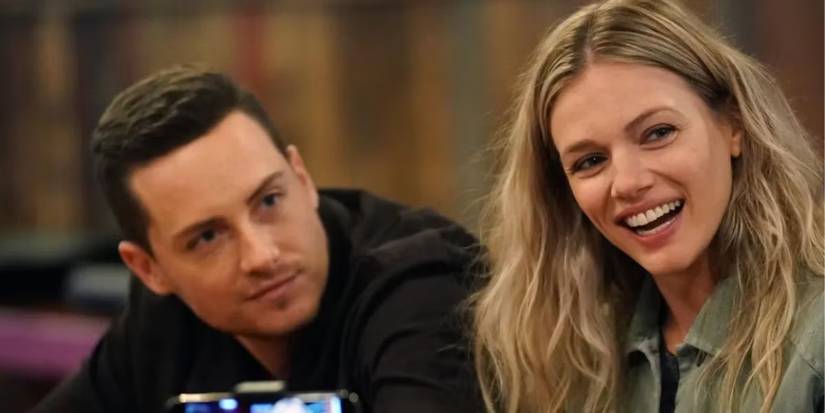 Halstead and Upton sitting next to each other smiling on 'Chicago P.D.'