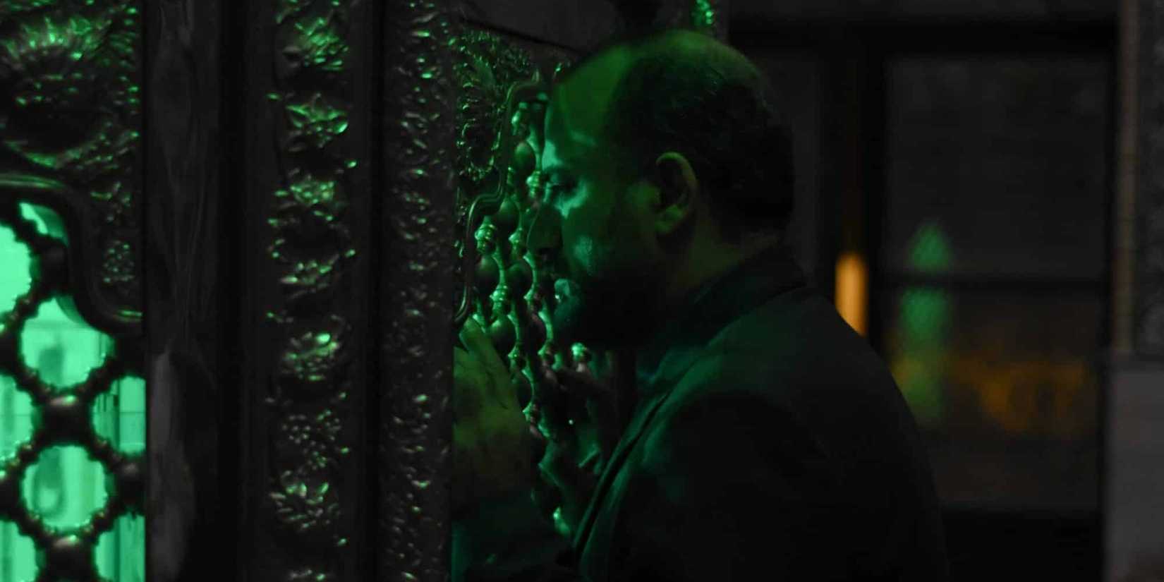 Iman (Missagh Zareh) standing in shadow in 'The Seed of the Sacred Fig'