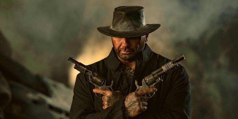 Dave Bautista holding two guns in In the Lost Lands