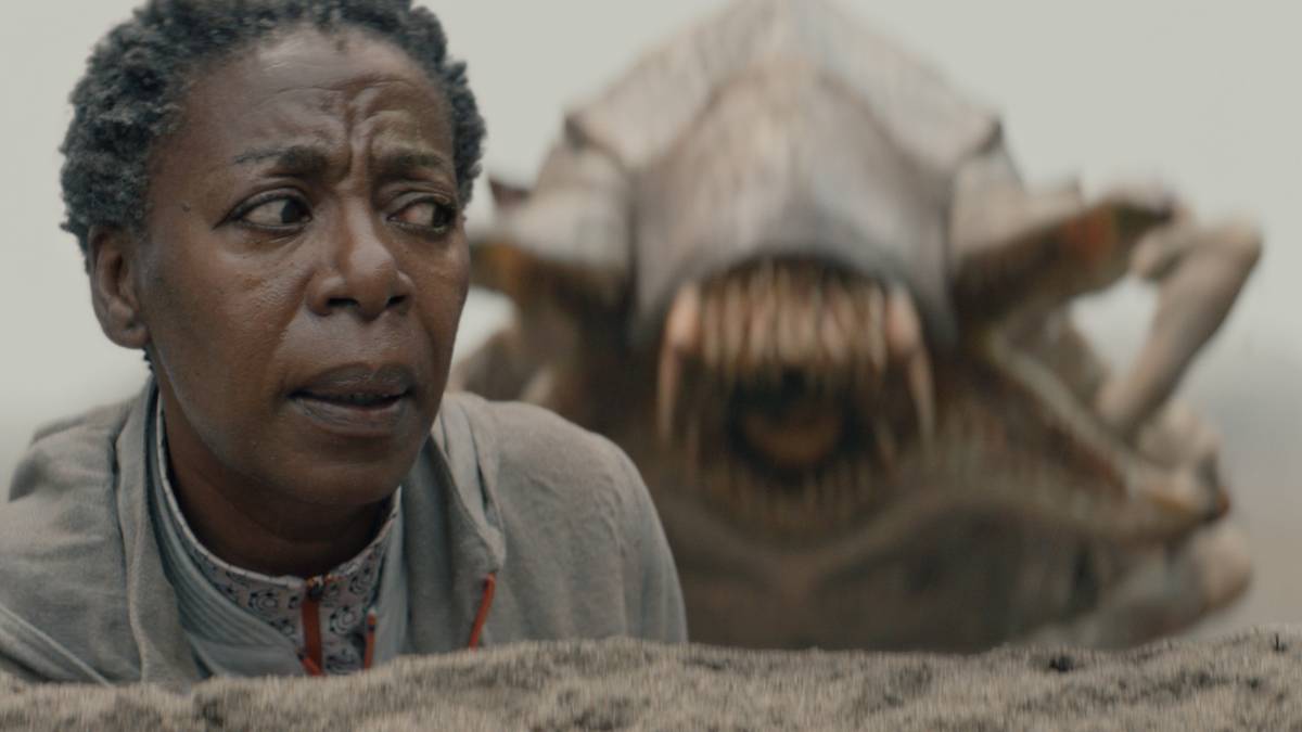A giant insect creature looming up behind Mensah (Noma Dumezweni) in Murderbot Episode 2