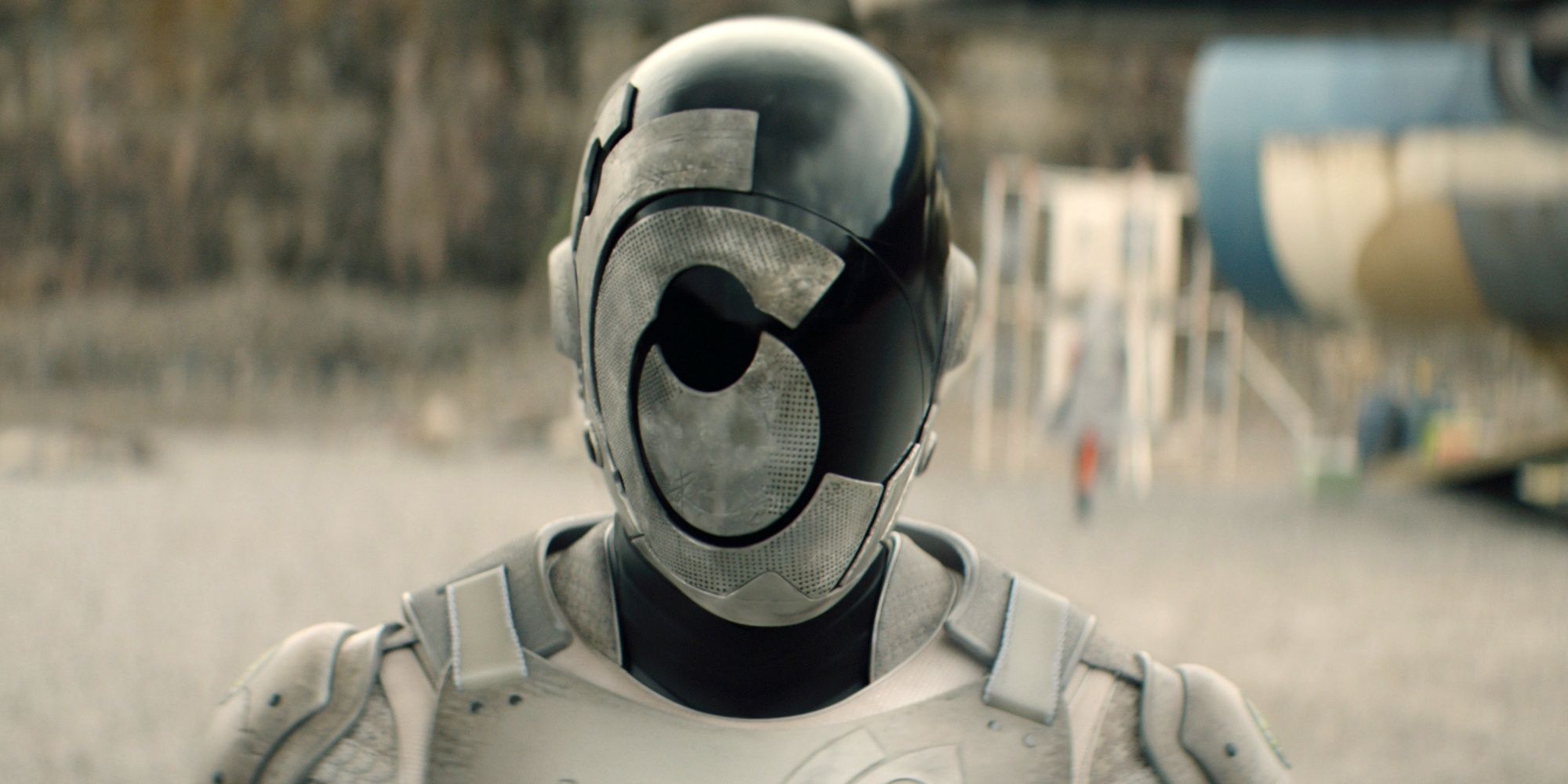Alexander Skarsgard as Murderbot in the SecUnit suit and helmet looking forward in Murderbot