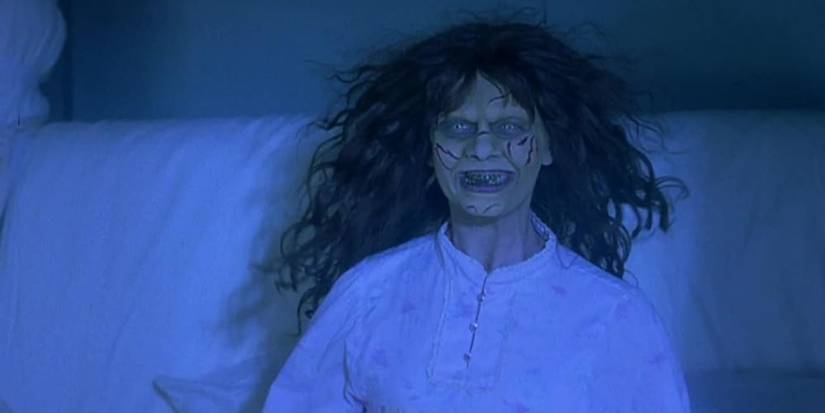 Natasha Lyonne as Megan Voorhees in 'Scary Movie 2', with wild hair and a cut face, parodying The Exorcist.
