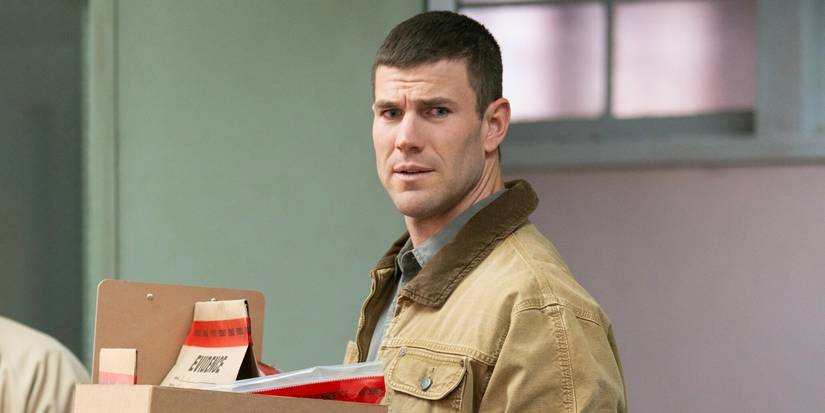 Austin Stowell as Leroy Jethro Gibbs carrying a box in NCIS: Origins Season 1, Episode 14.