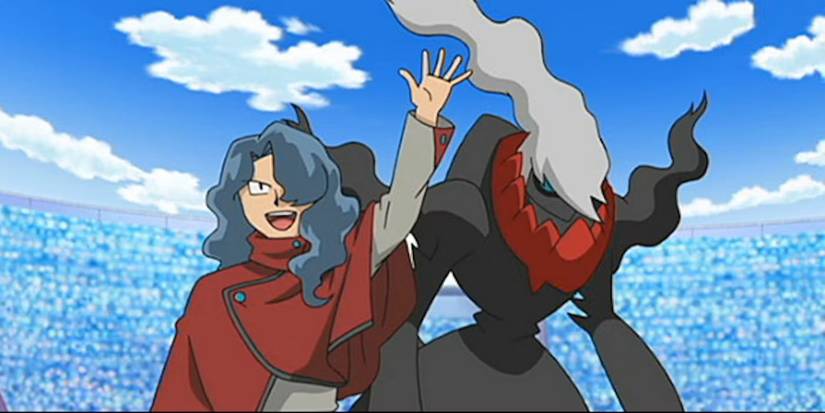 Tobias waves to a crowd with his Darkrai