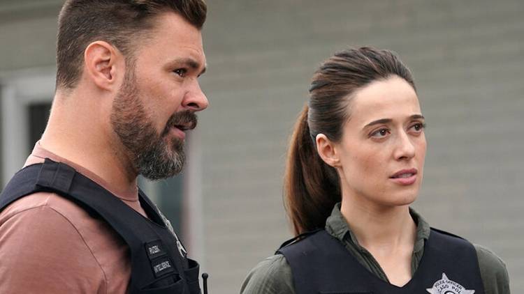 Ruzek and Burgess in Season 1 of Chicago P.D. standing outside in their work gear