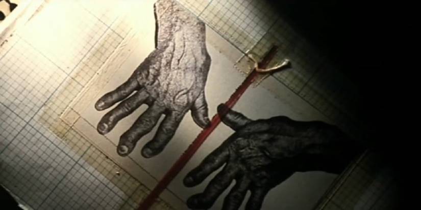 Images of two photographed hands from the opening credits in Se7en.