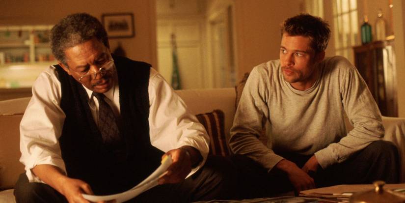 Morgan Freeman and Brad Pitt sitting on a couch in Se7en.