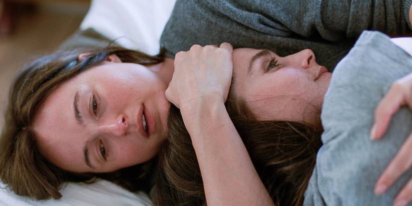 Renate Reinsve as Nora Berg holding Inga Ibsdotter Lilleaas as Agnes in Sentimental Value.