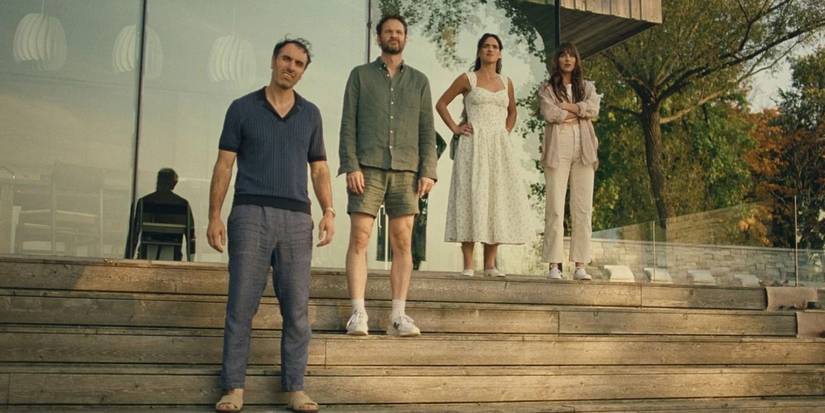 Michael Angelo Covino, Kyle Marvin, Adria Arjona and Dakota Johnson standing on the stairs in Splitsville  