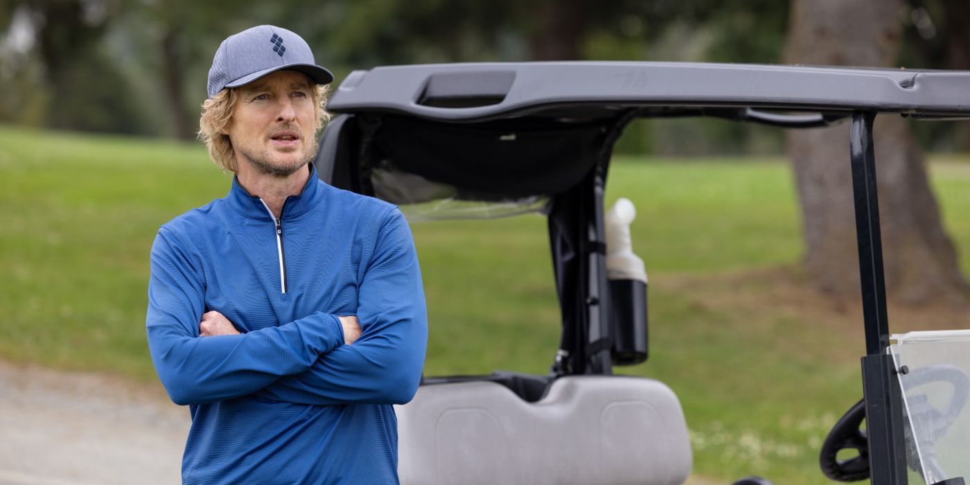 Owen Wilson as Pryce Cahill in 'Stick' stands with his arms folded on the golf course.