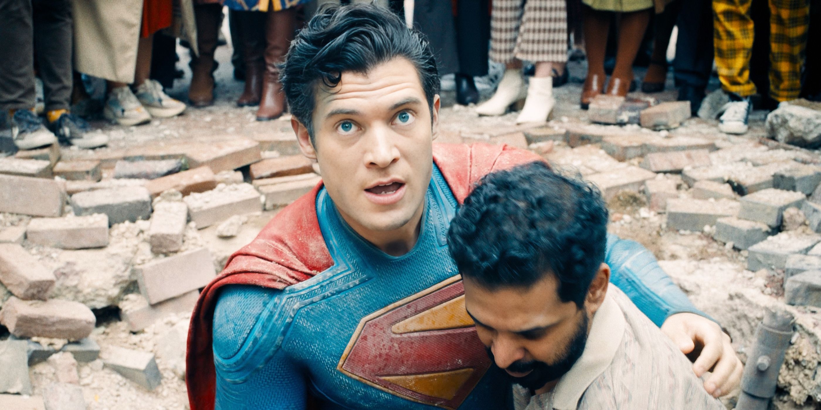 David Corenswet as Superman being held up by a man in 'Superman.'