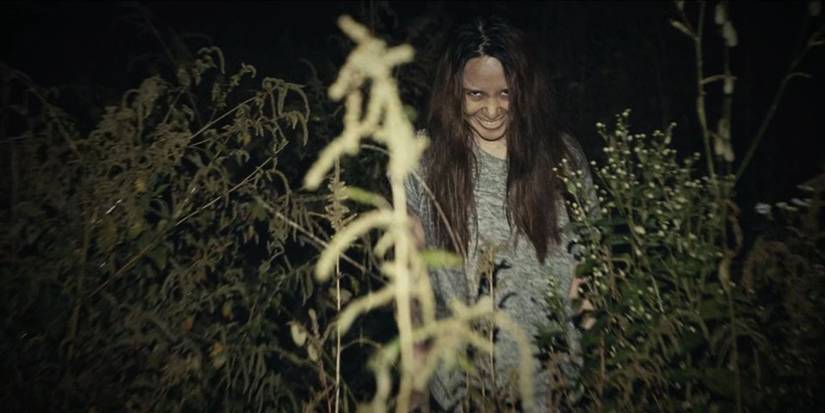 Narilya Gulmongkolpech as Mink smiling creepily in a field in The Medium